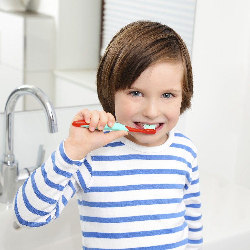 Cute boy brushing teeth.